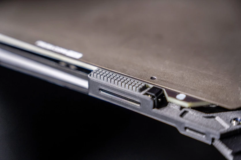 The nozzle wiper mounted at the front edge of the heatbed, a standard consumable part owners are meant to replace themselves (Prusa Research)